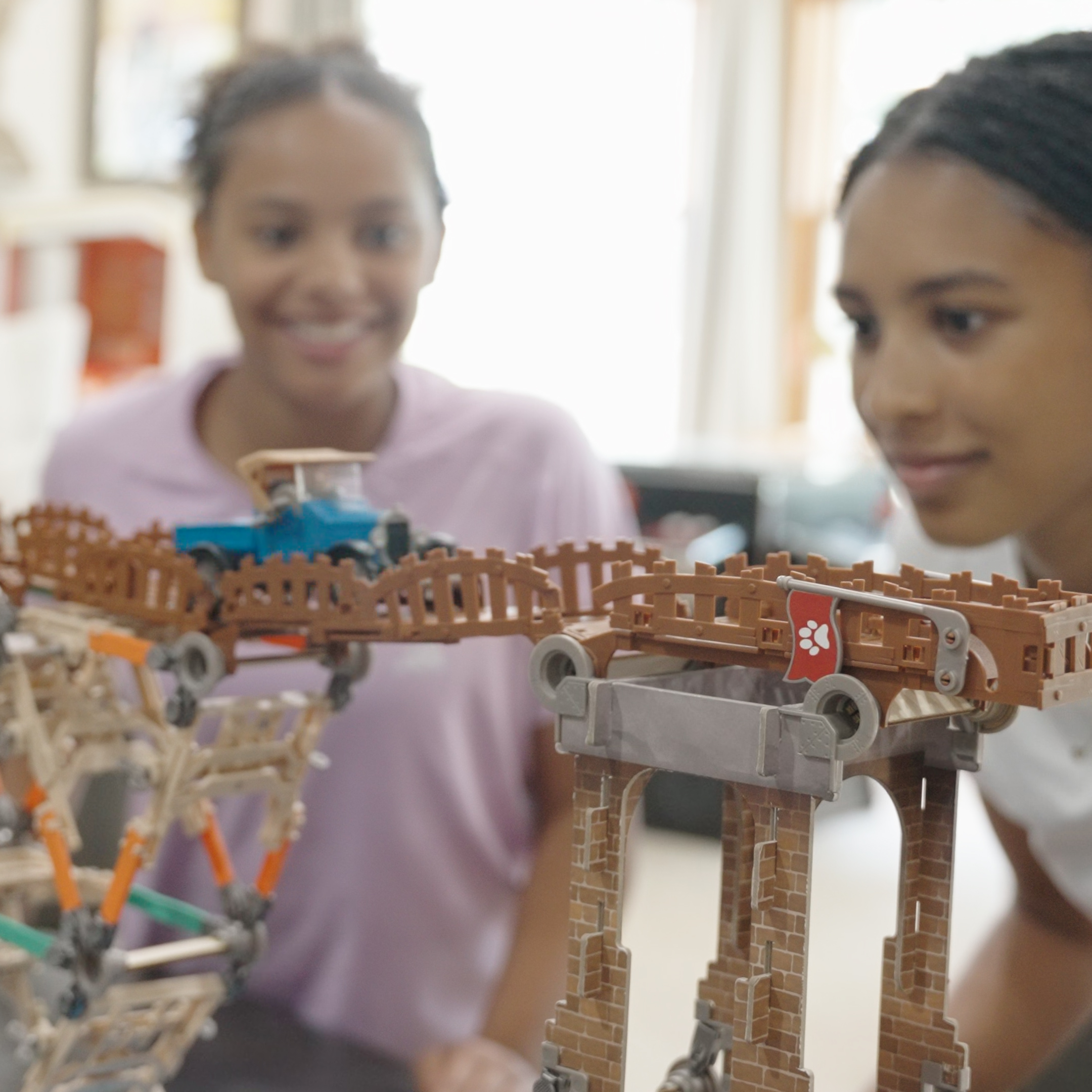 ingenious girls playing with bridge and bust